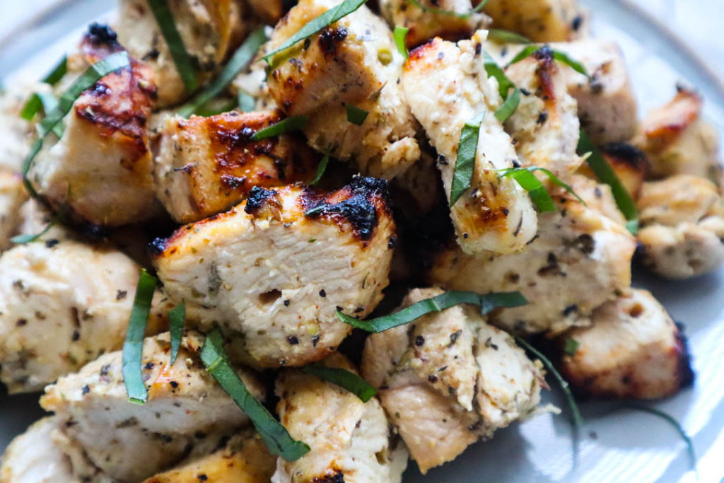 grilled herbs de provence chicken topped with basil 