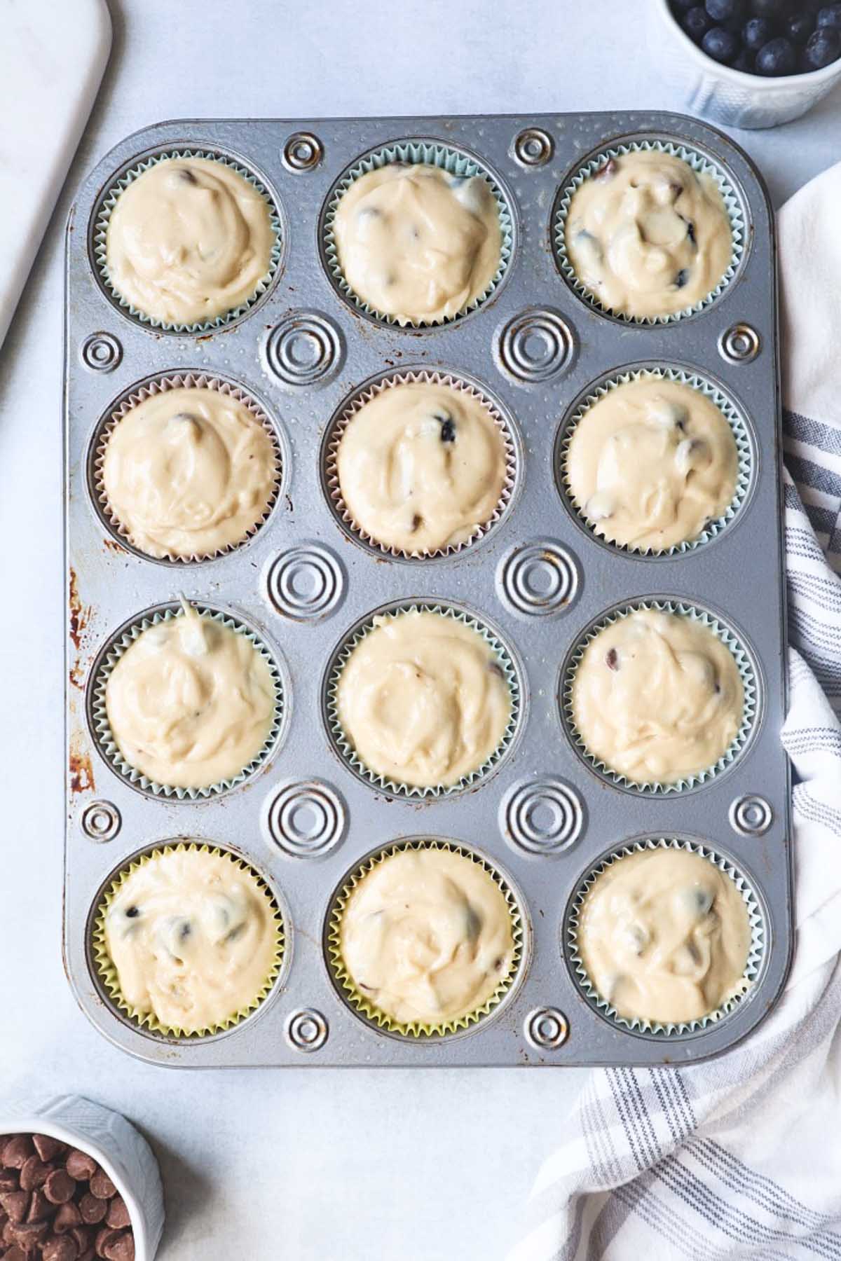 blueberry chocolate muffin batter in muffin tin
