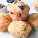 4 fresh baked blueberry chocolate chip muffins stacked on one another