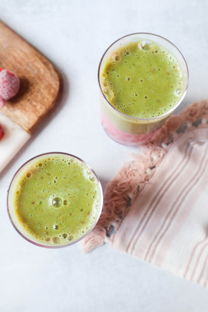 bird eye view of two glasses containing matcha strawberry smoothie