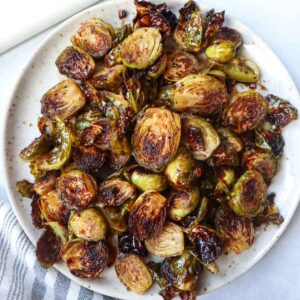 white plate with roasted maple balsamic brussel sprouts