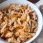 white bowl with dutch oven pulled chicken