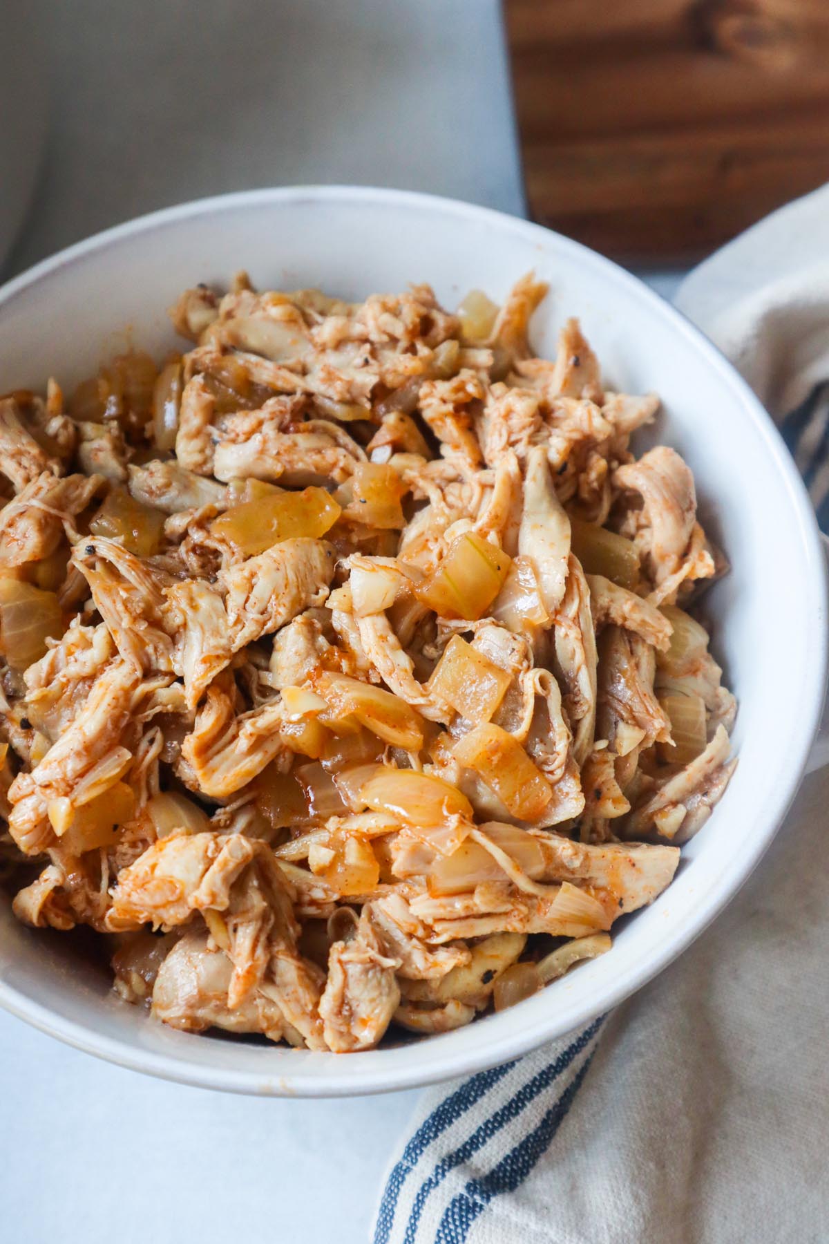 white bowl with dutch oven pulled chicken
