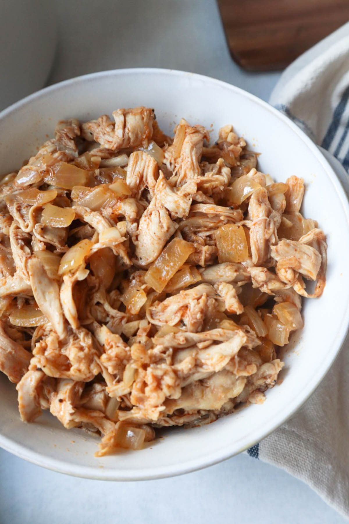 white bowl with dutch oven pulled chicken