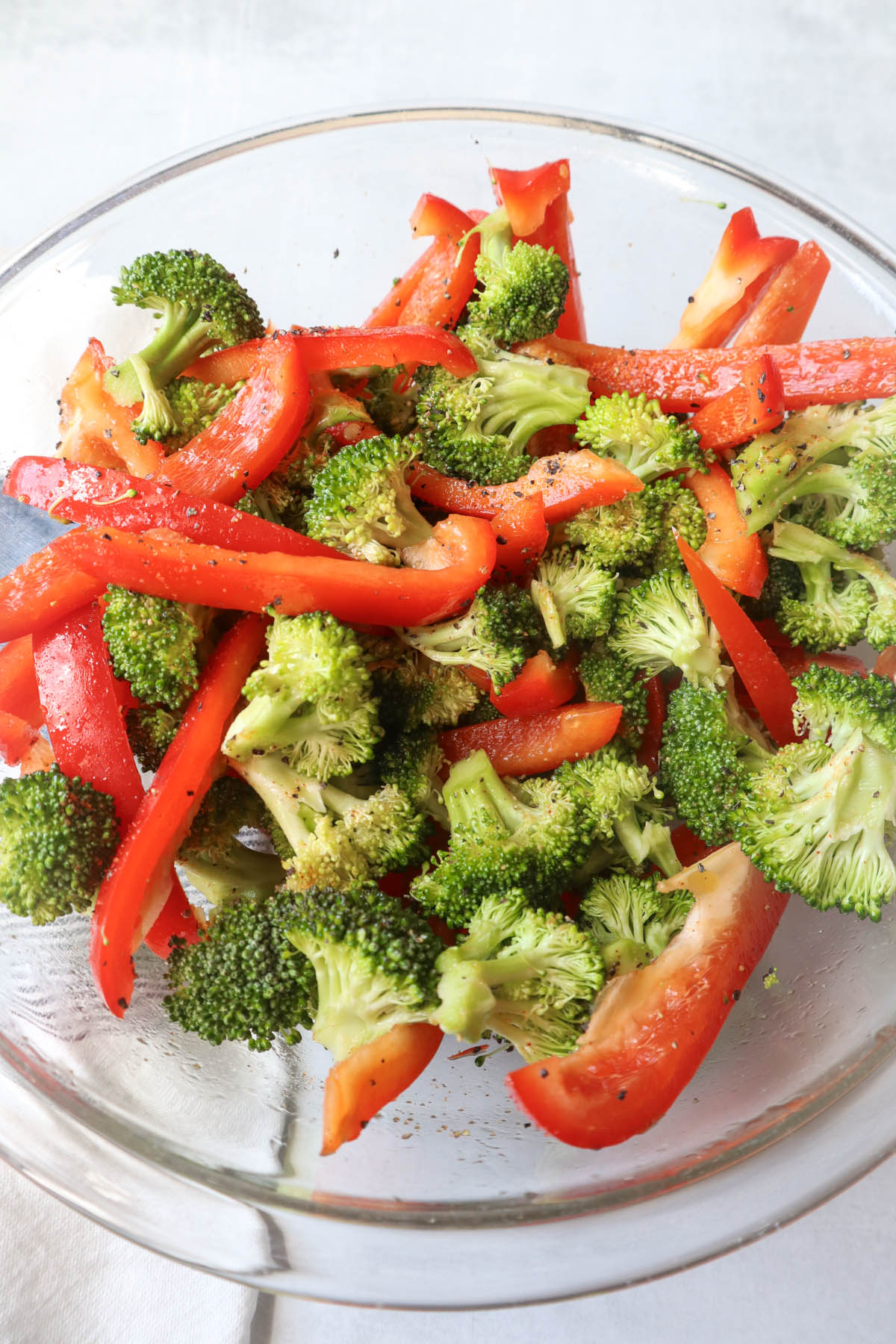 glass bowl with seasoned red pepper and broccoli