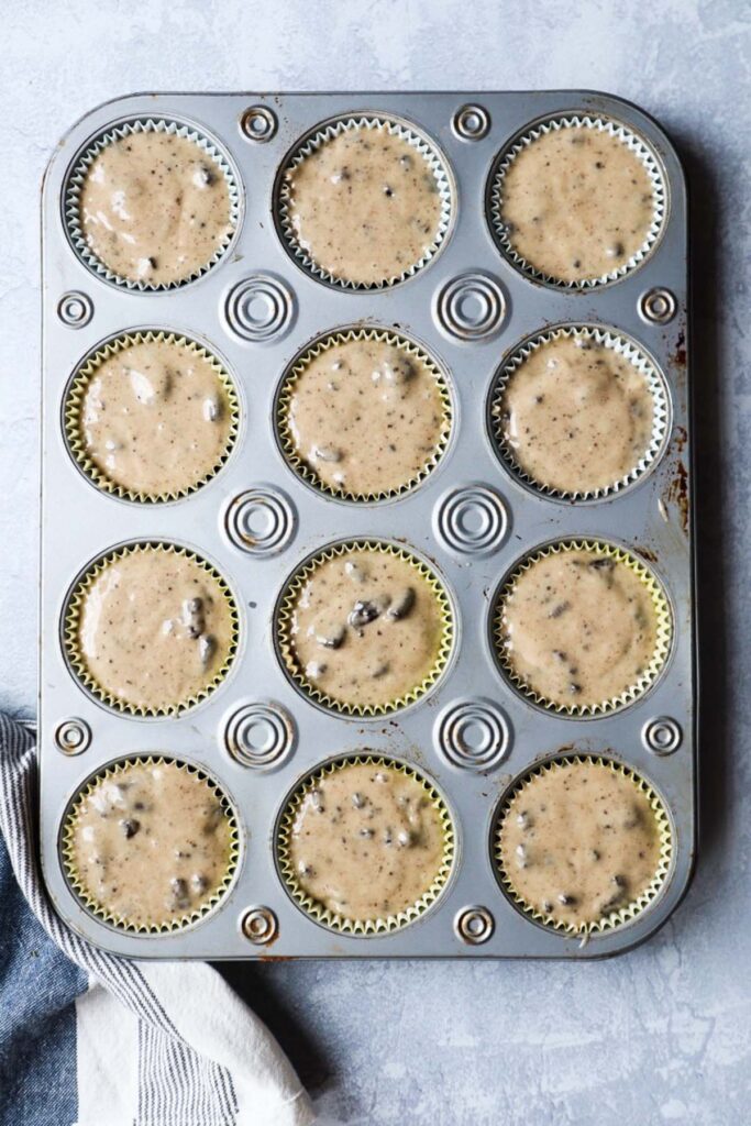 muffin pan with muffin liners with oreo muffin batter