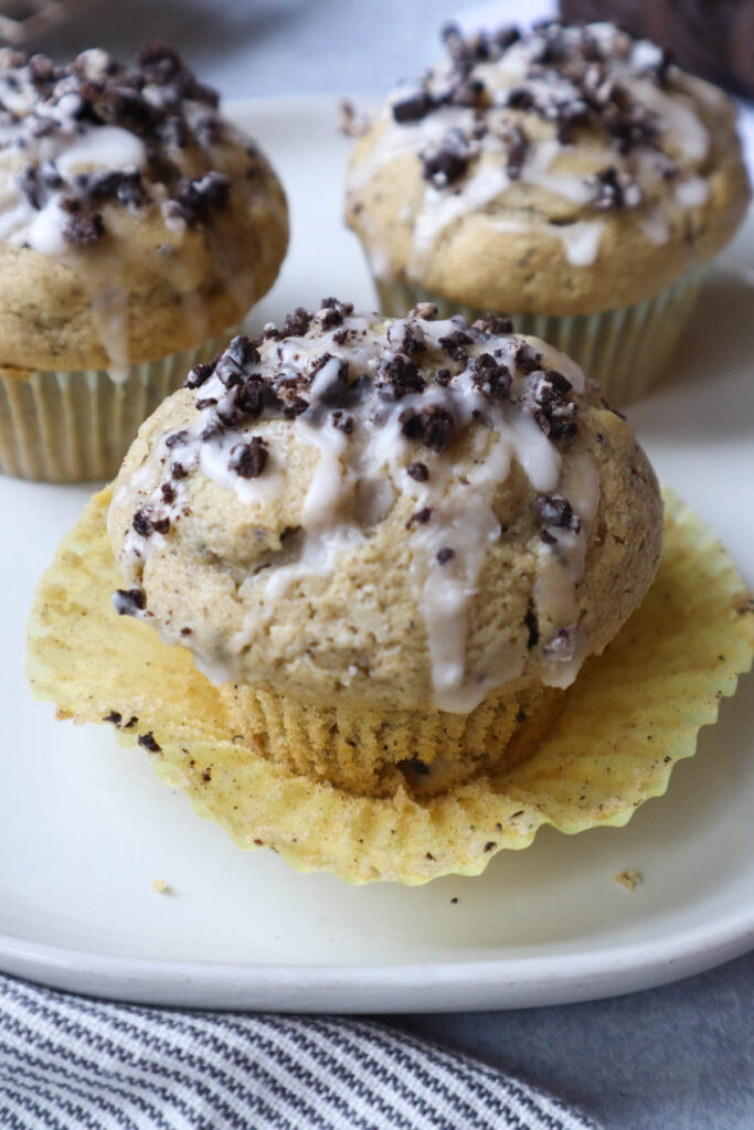 muffin on plate with cookie crumbs and glaze