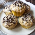 plate with oreo muffins stacked with oreo crumbs and glaze