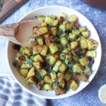 white bowl with pan fried potatoes with dill and parsley
