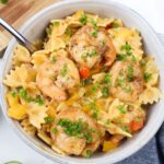 bowl with creamy jerk shrimp pasta topped with parsley