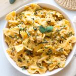 butternut squash feta pasta in a white bowl topped with fresh sage.