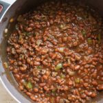 pot with cooked baked beans and ground beef.