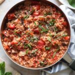 chicken cacciatore topped with fresh basil in a skillet.