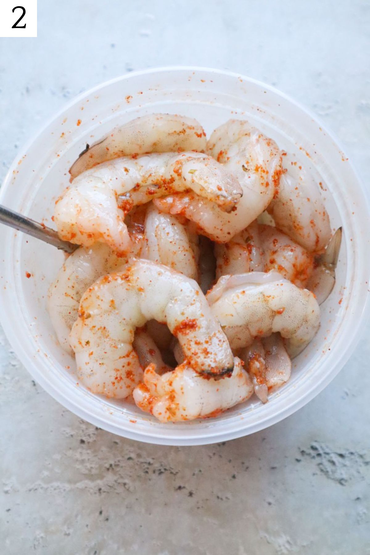 bowl with shrimp coated in cajun seasoning.