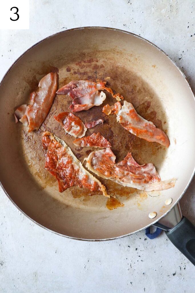 skillet with sliced prosciutto being fried until crispy.