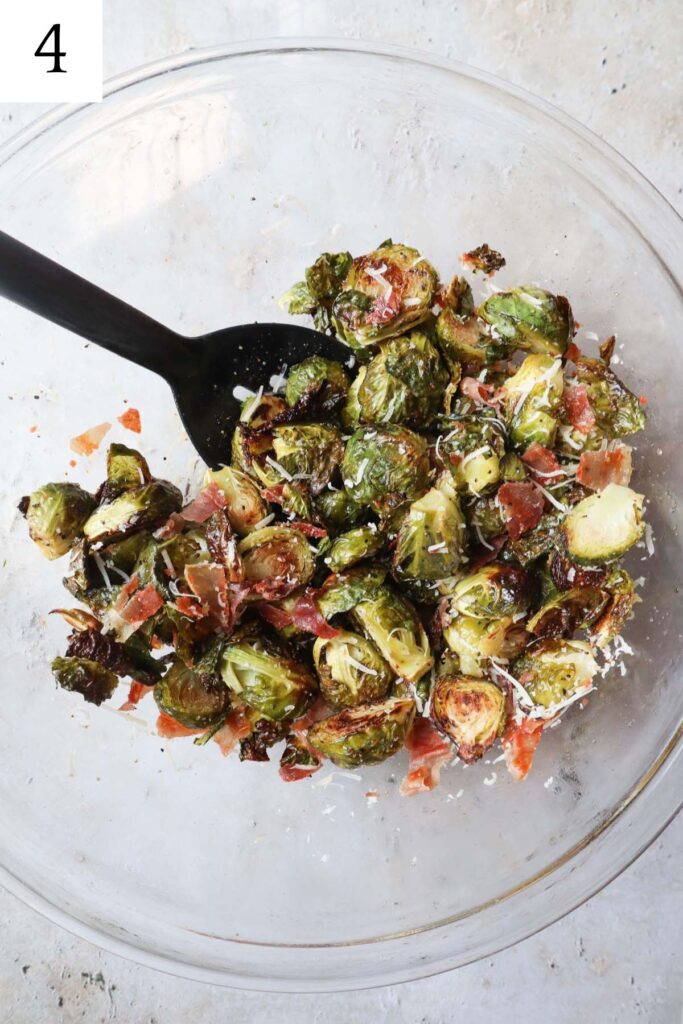 glass bowl with brussels sprouts, prosciutto, parmesan cheese, and balsamic glaze.