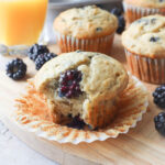 blackberry banana muffin with bite taken out showing a blackberry.