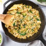 skillet with lemon orzo topped with parsley and feta cheese.
