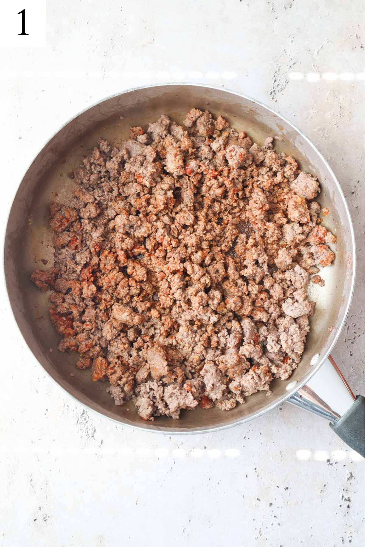 skillet with seasoned cooked ground beef.