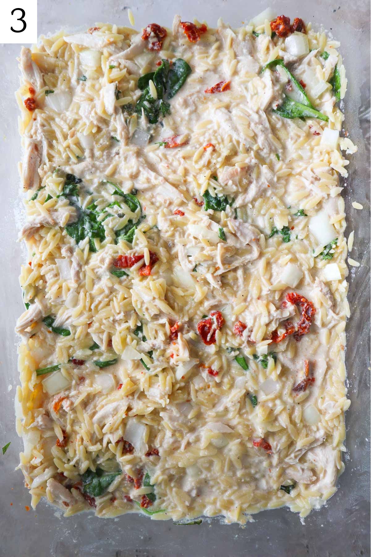 glass baking dish of baked chicken boursin orzo.