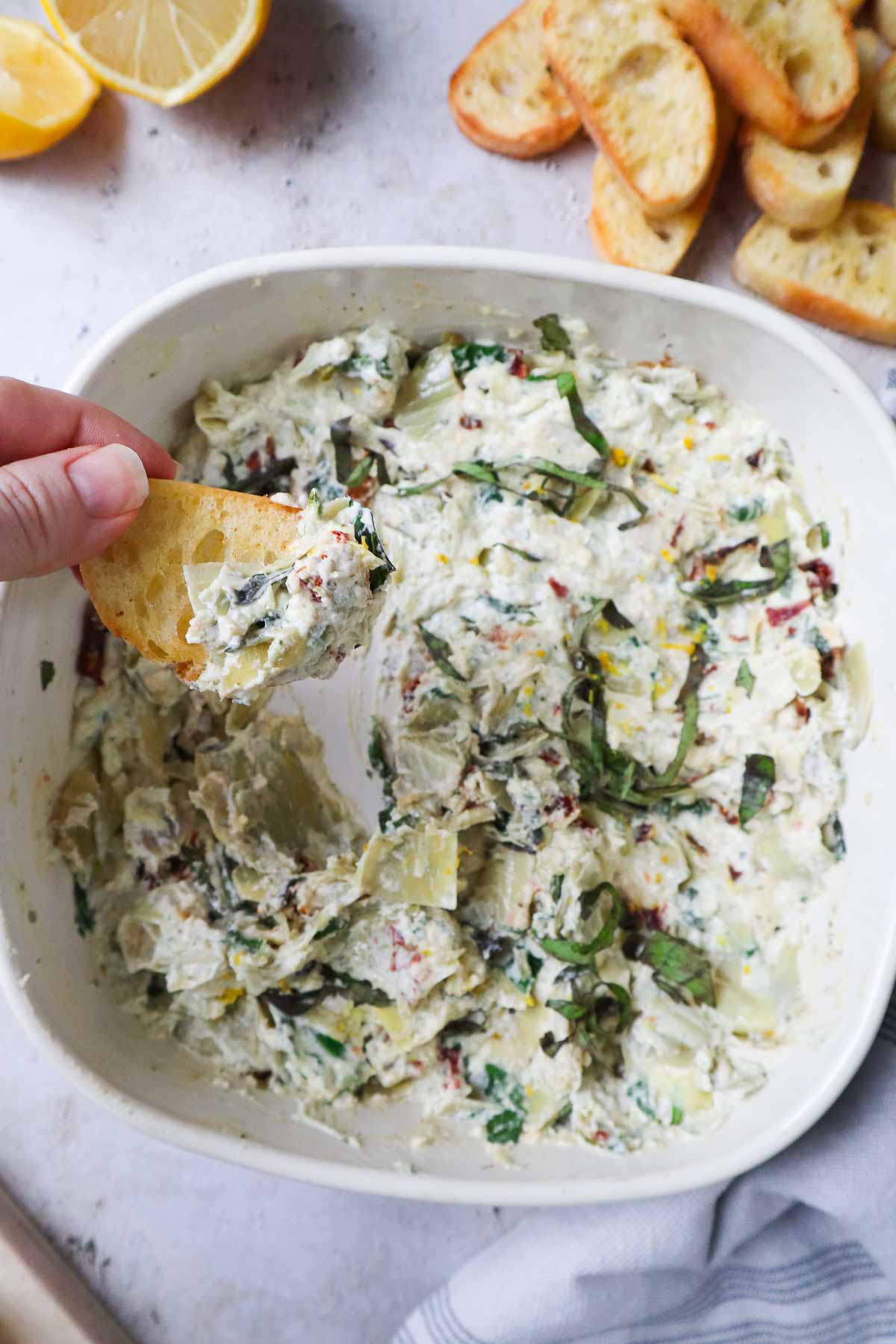 crostini scooping boursin cheese dip.