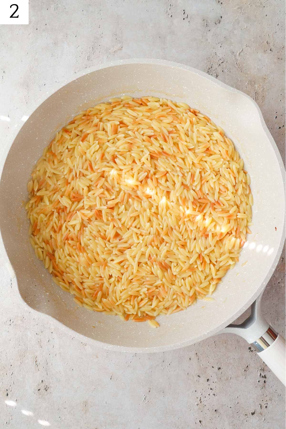 skillet with toasted orzo.