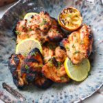 bowl with grilled lemon pepper chicken thighs.