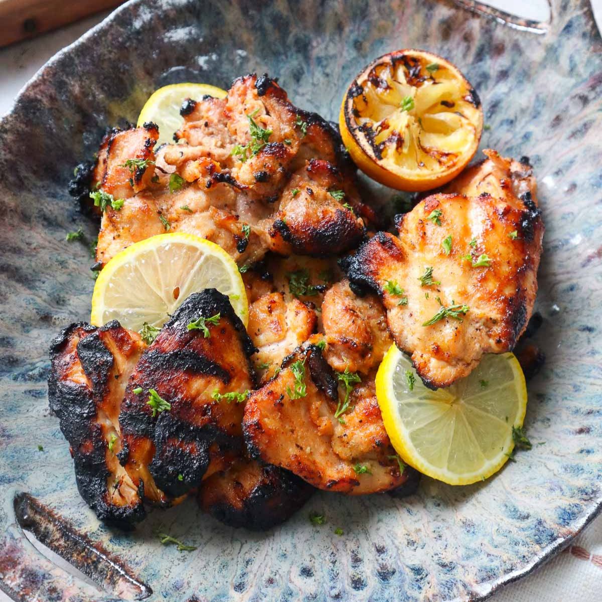 bowl with grilled lemon pepper chicken thighs.
