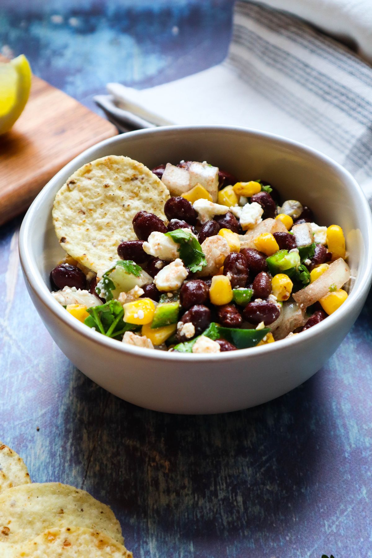 white bowl with black bean corn feta dip.