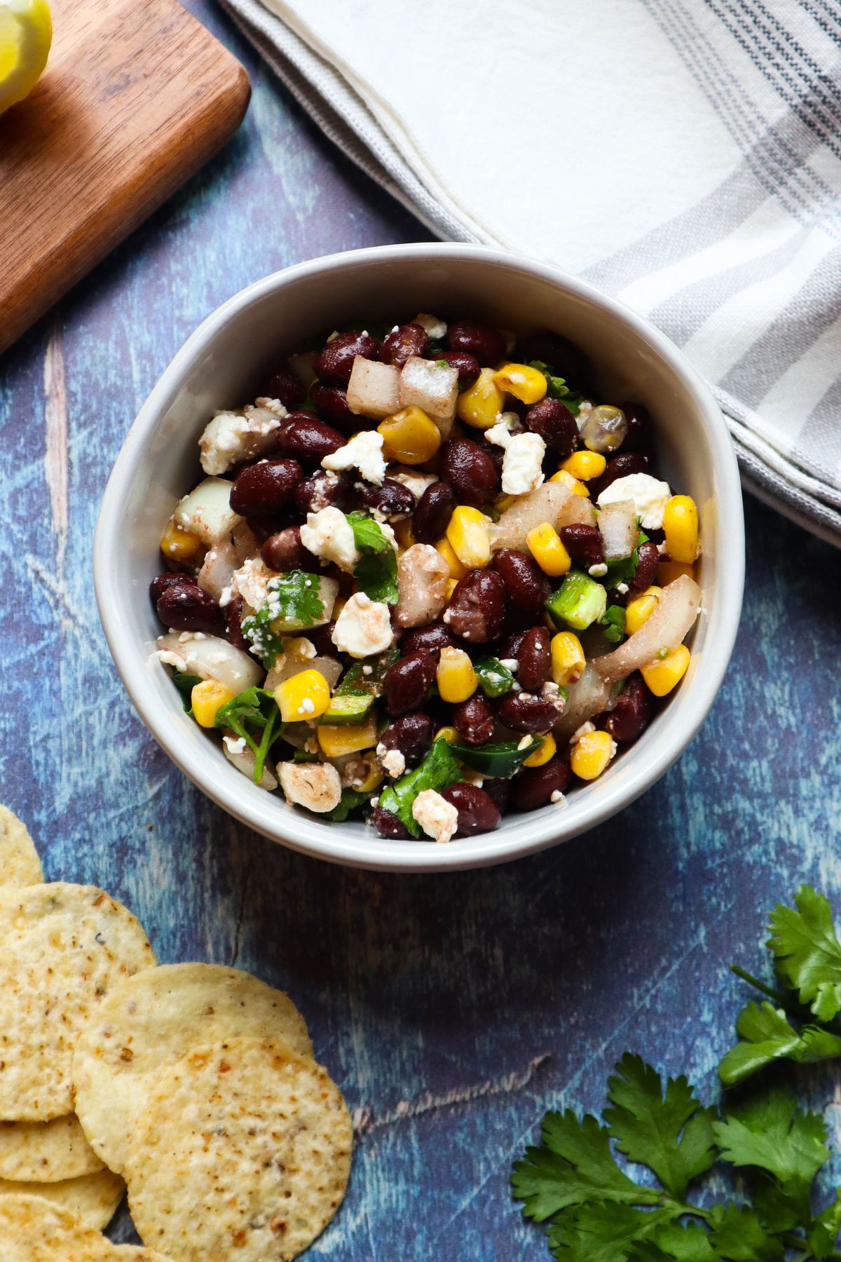 white bowl with black bean corn feta dip.