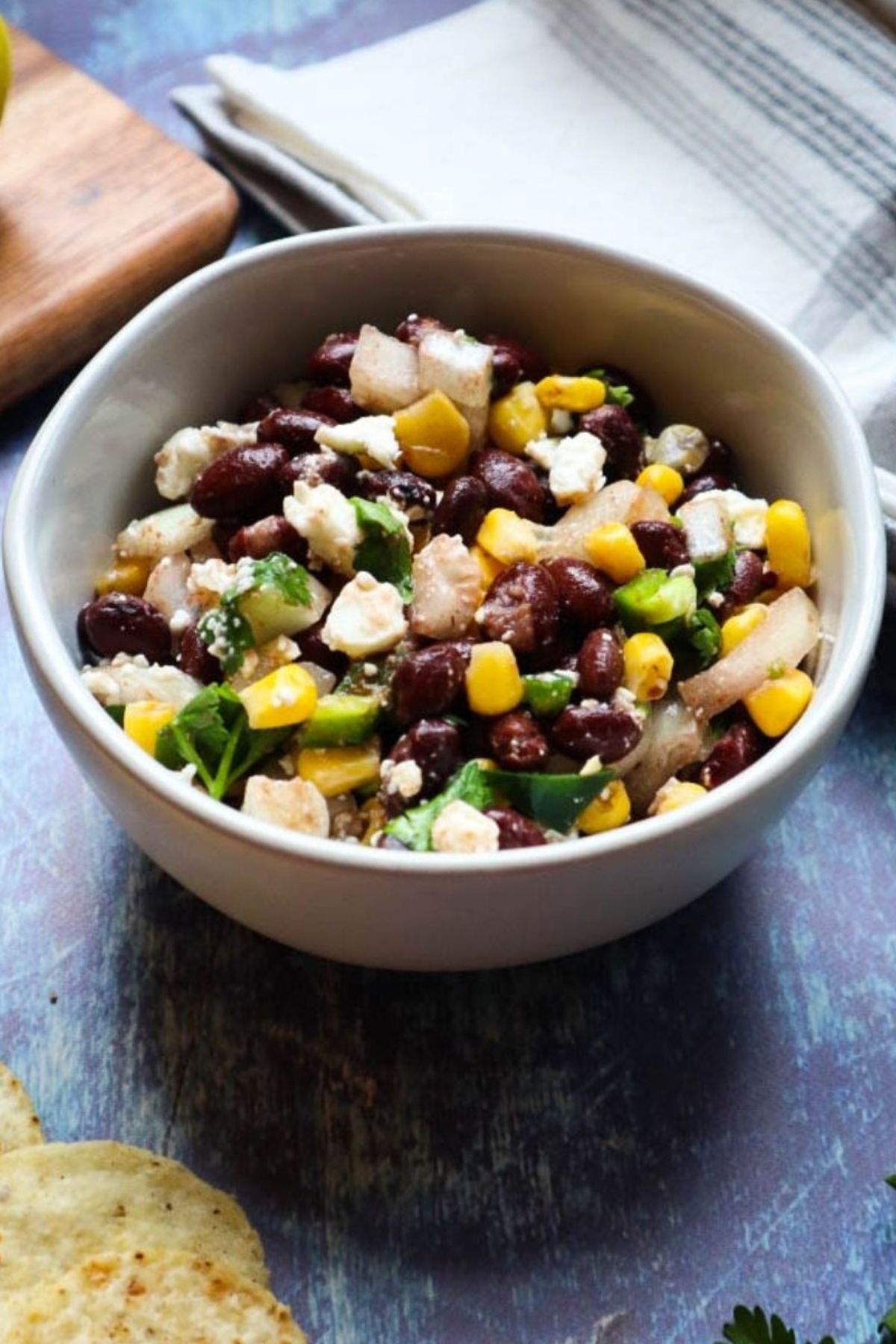 white bowl with black bean corn feta dip.