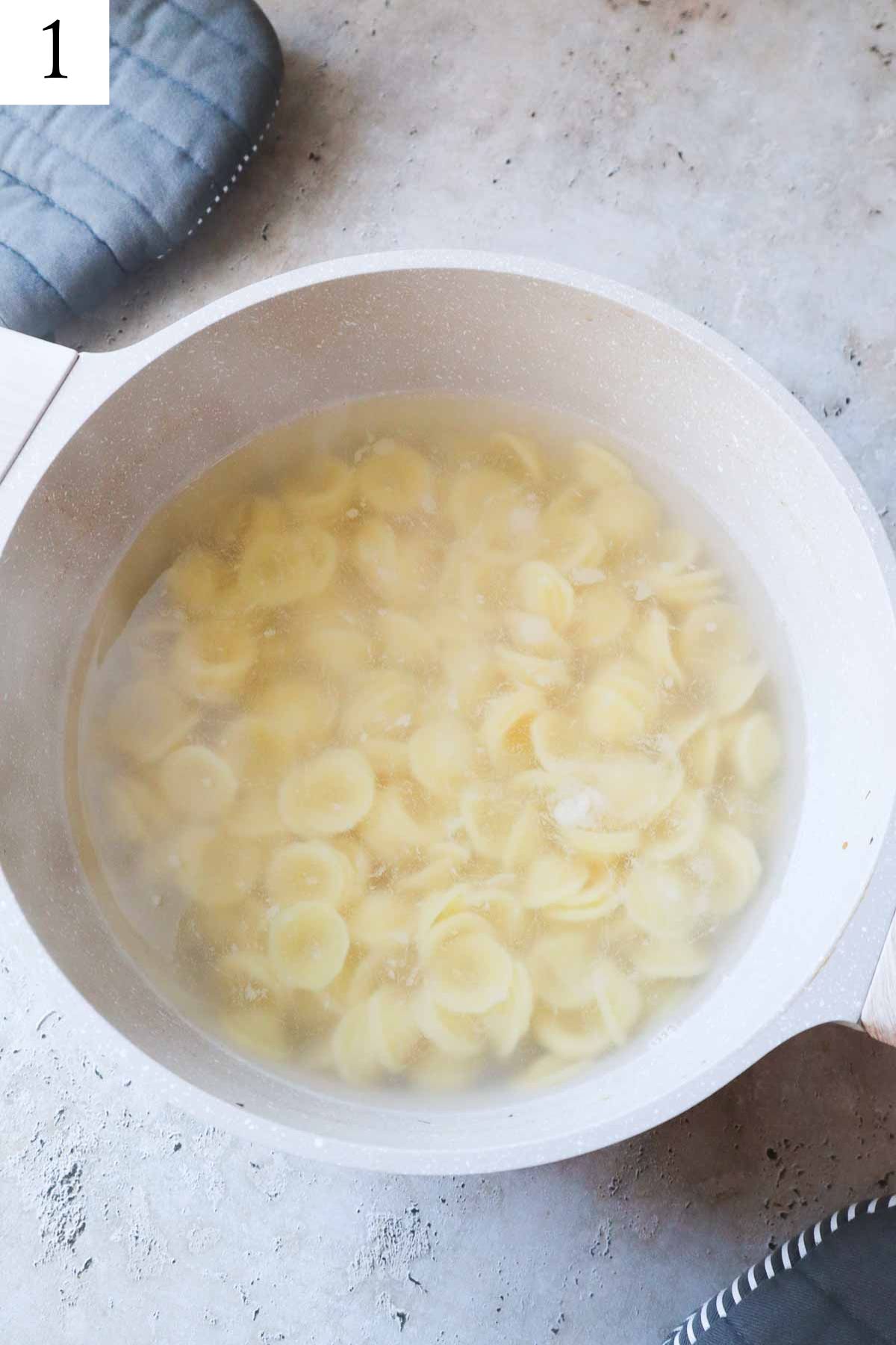 pot of boiled water and pasta.