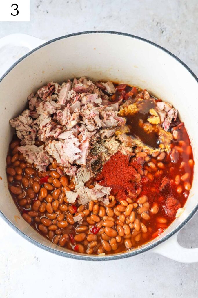 dutch oven with all ingredients to make brisket baked beans.