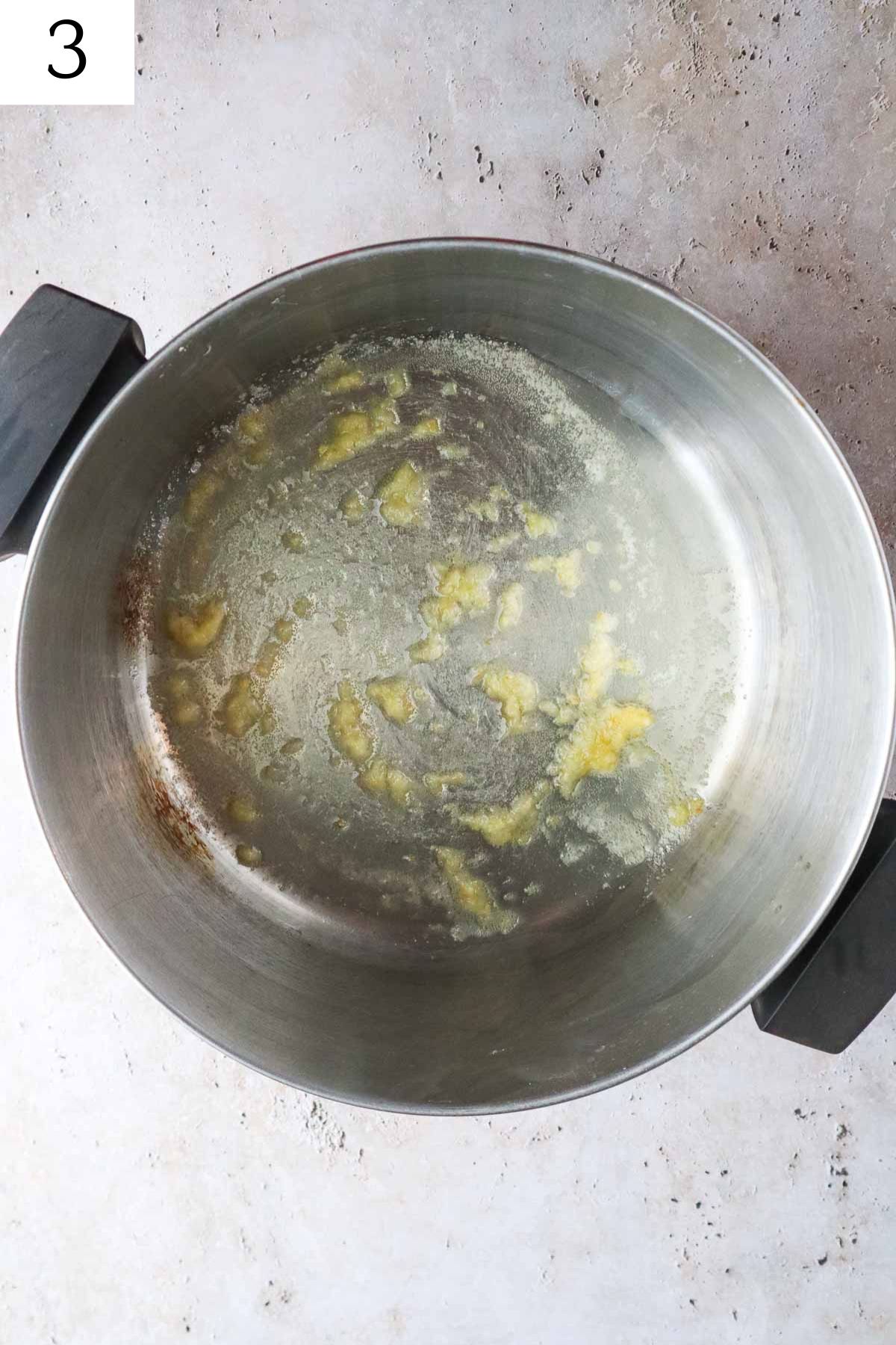 pot with sauteed garlic and ginger.