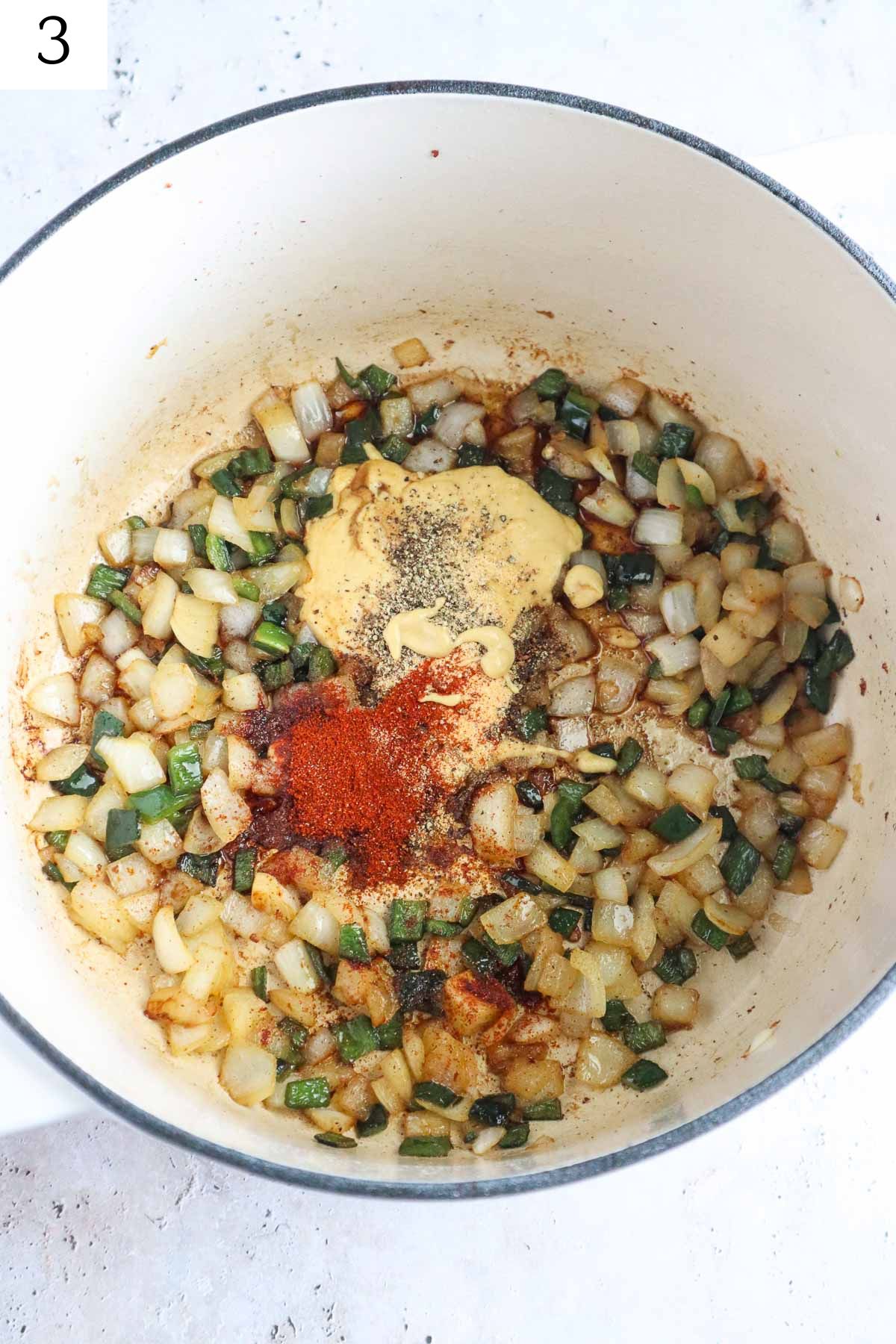 dutch oven with sauteed onion, pepper, and seasonings.
