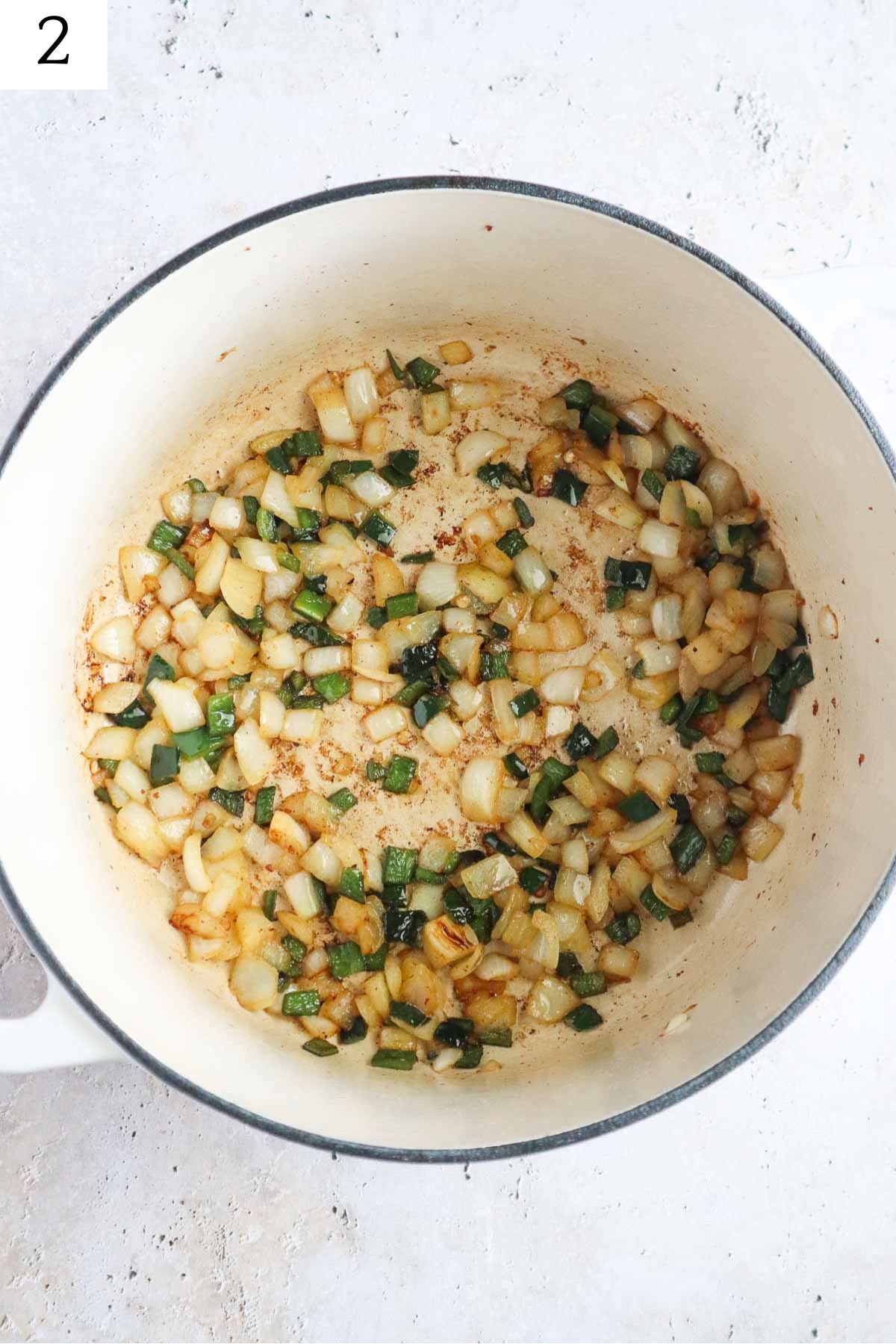dutch oven with sauteed onion and poblano pepper.