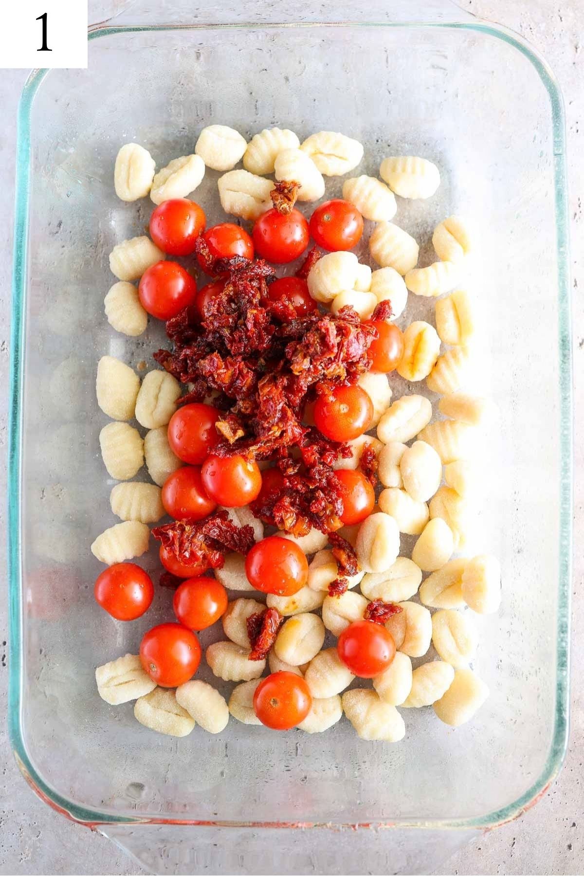 glass baking dish with gnocchi and tomatoes.