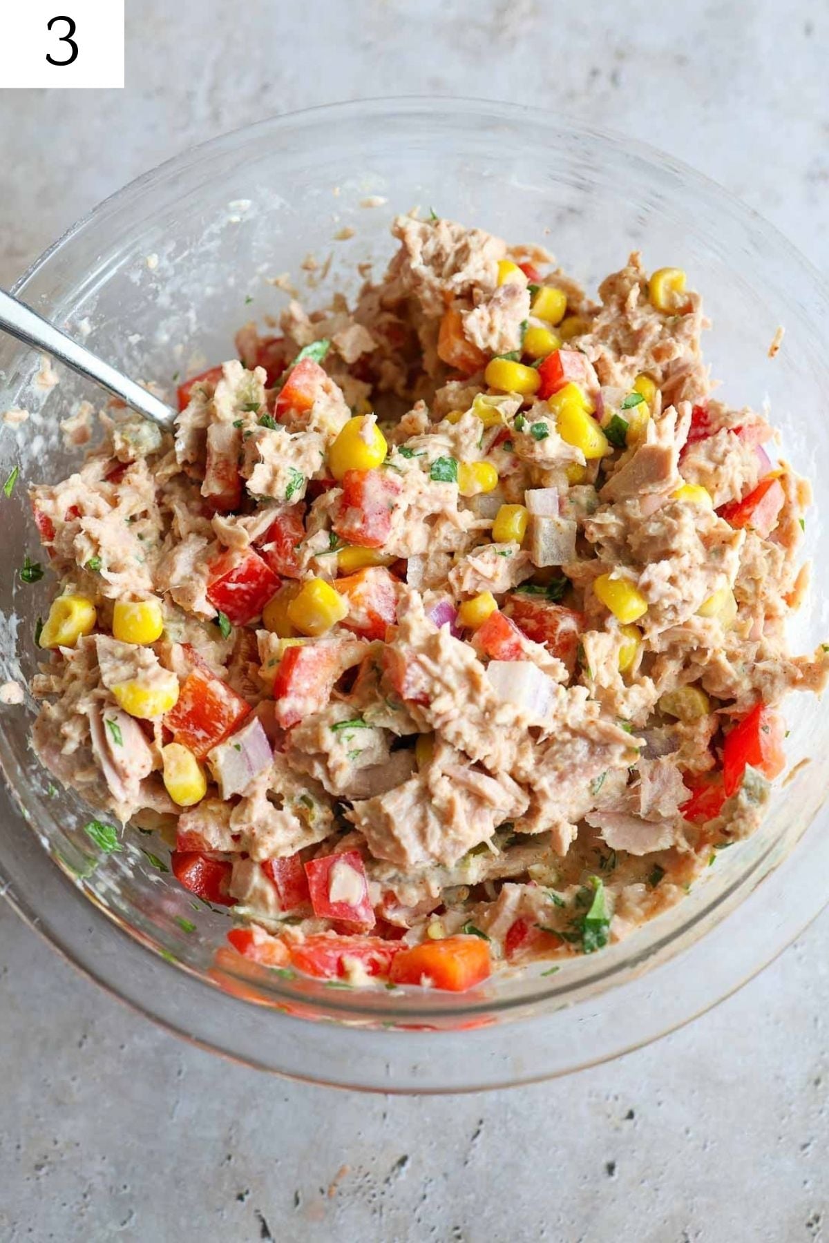 glass bowl with tuna corn salad.