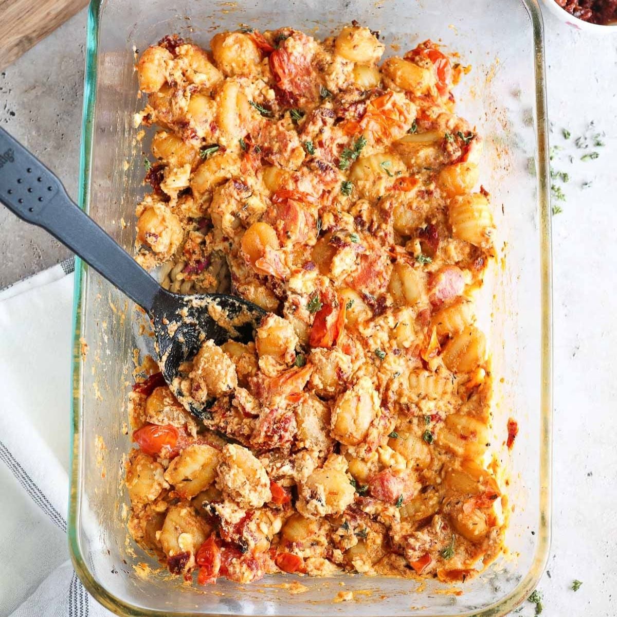 glass baking dish with fully baked feta gnocchi.